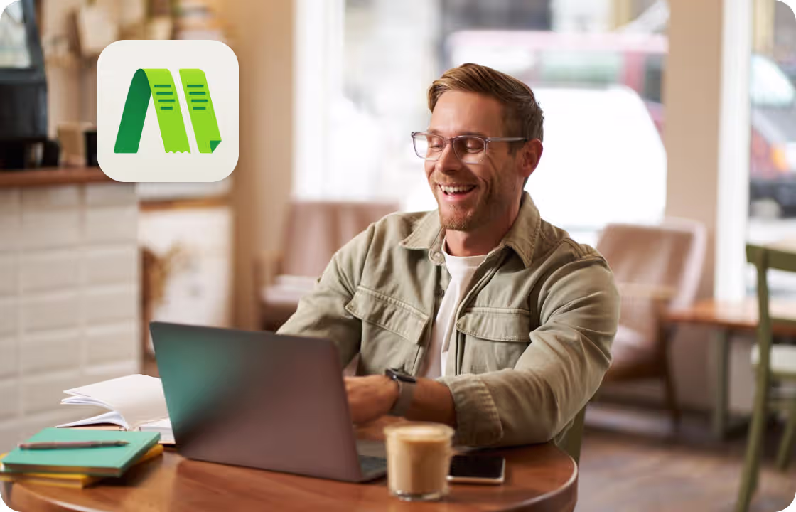 A man works on a laptop in a café, with ccMonet’s app icon shown. It represents SME owners (like café operators) using our AI - powered financial tools (bookkeeping, dashboards) and expert services (compliance, tax support) to manage business finances flexibly.