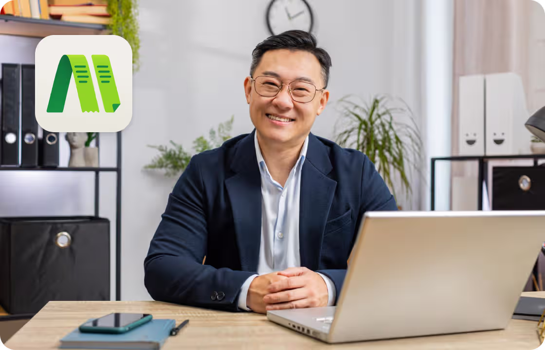 A man sits at a tidy office desk with a laptop, surrounded by the ccMonet logo. It shows how our AI - powered finance tools (bookkeeping, dashboards) and expert services (tax compliance, business support) help professionals manage finances smoothly and efficiently.