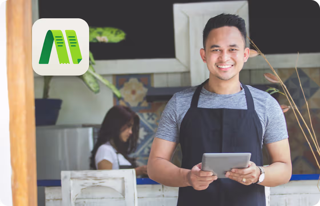 A man in an apron uses a tablet in a café setting, with the ccMonet logo. It shows how our AI - powered finance tools (bookkeeping, dashboards) and expert services (tax compliance, business support) help SMEs, like food businesses, manage finances easily and efficiently.